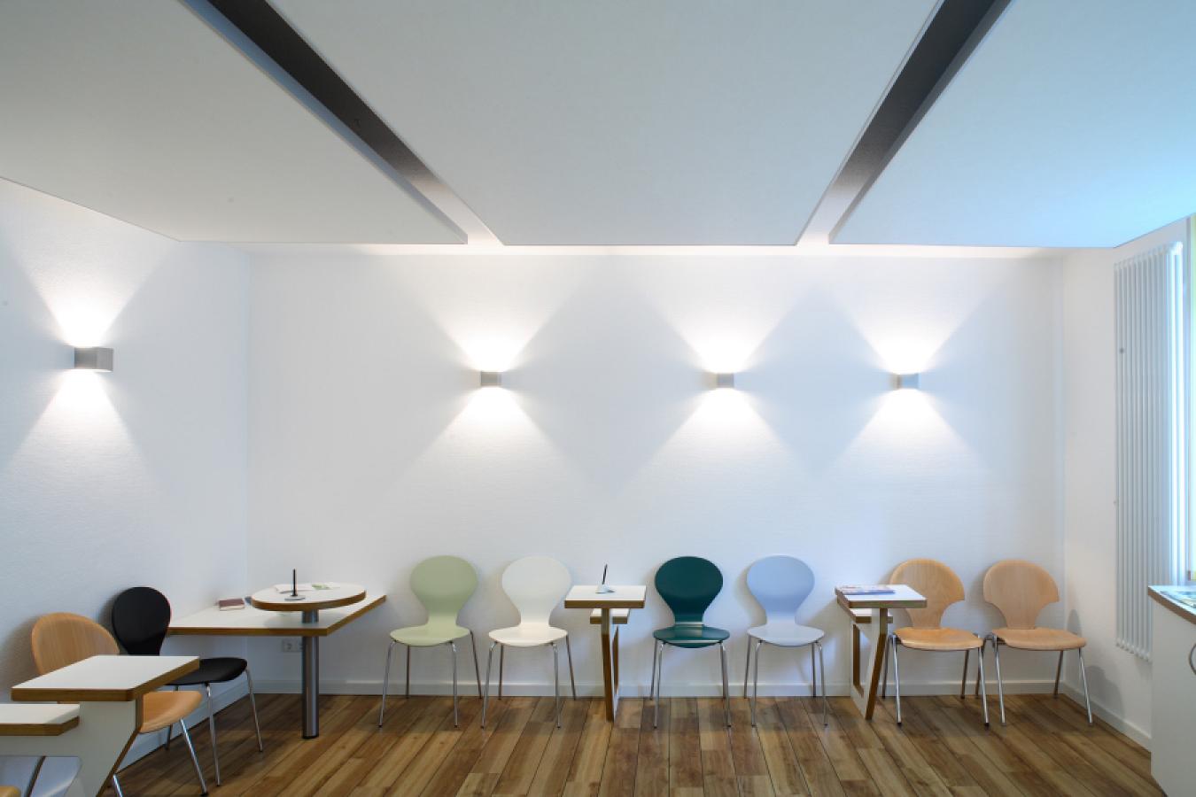 table elements and acoustic ceiling sails in a waiting room of a doctor's surgery