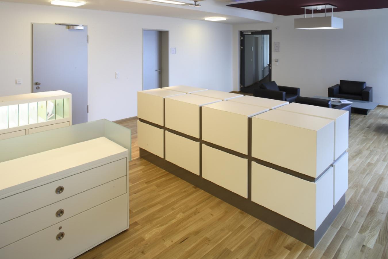 white cupboard unit consisting of several cubes with wide dark shadow gap and plinth