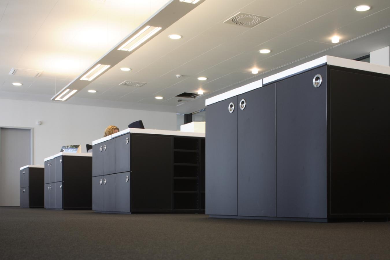 black cabinets as storage space underneath desk tops