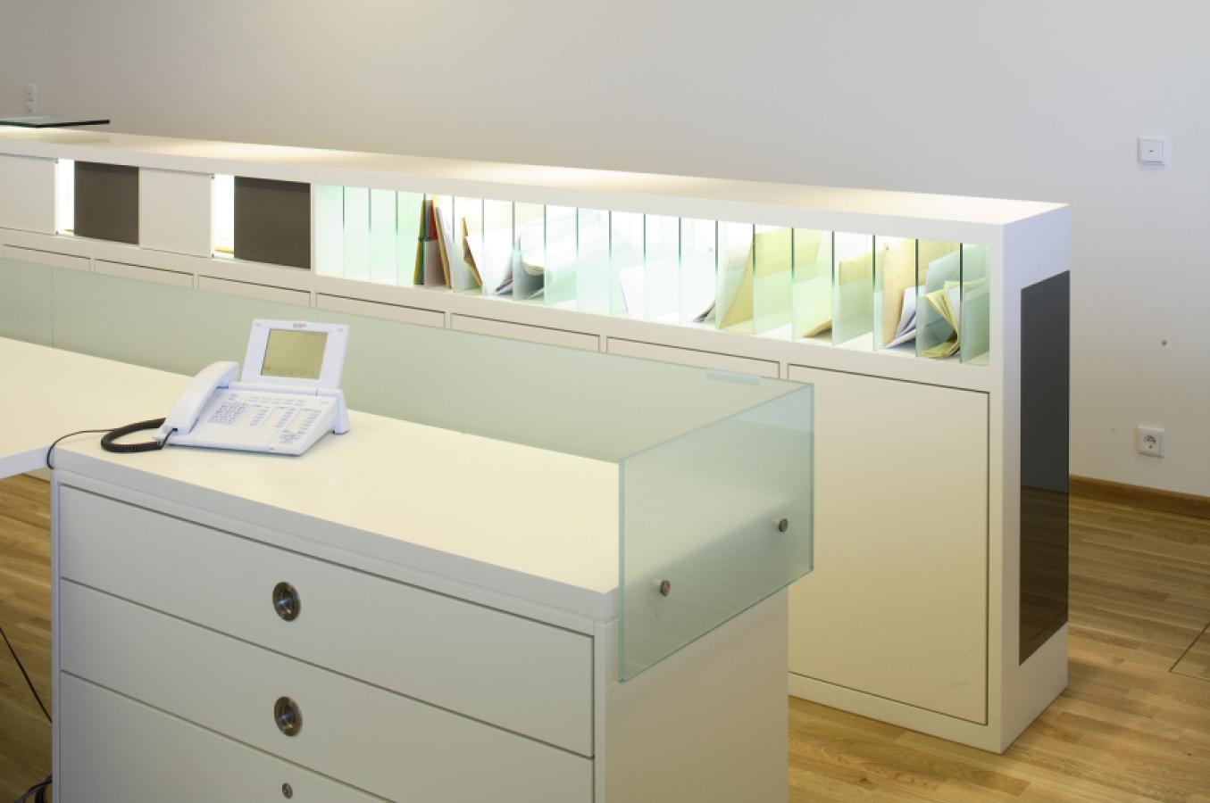 white cabinet unit with illuminated compartment and glass dividers