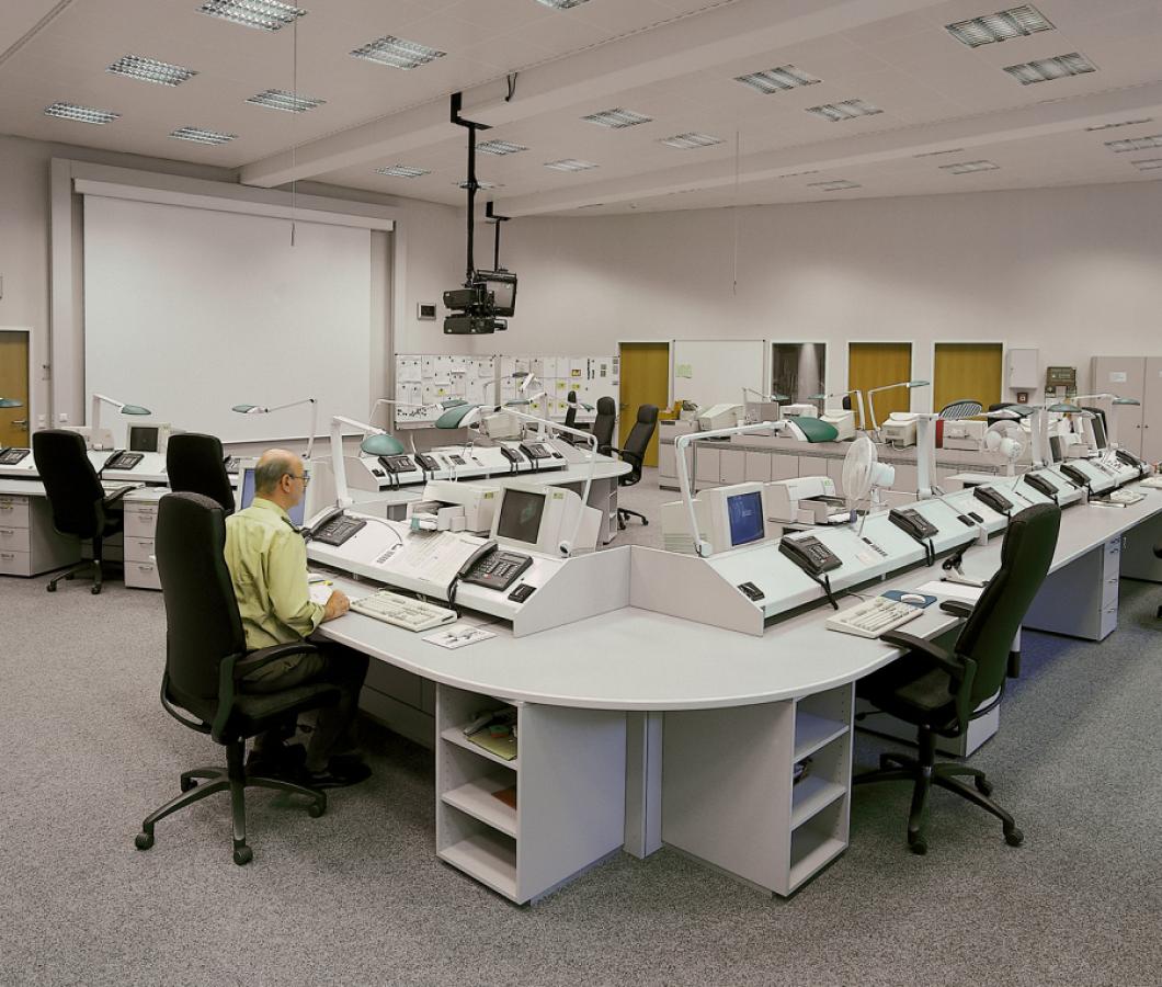 white workstation furniture with integrated technology in a control centre