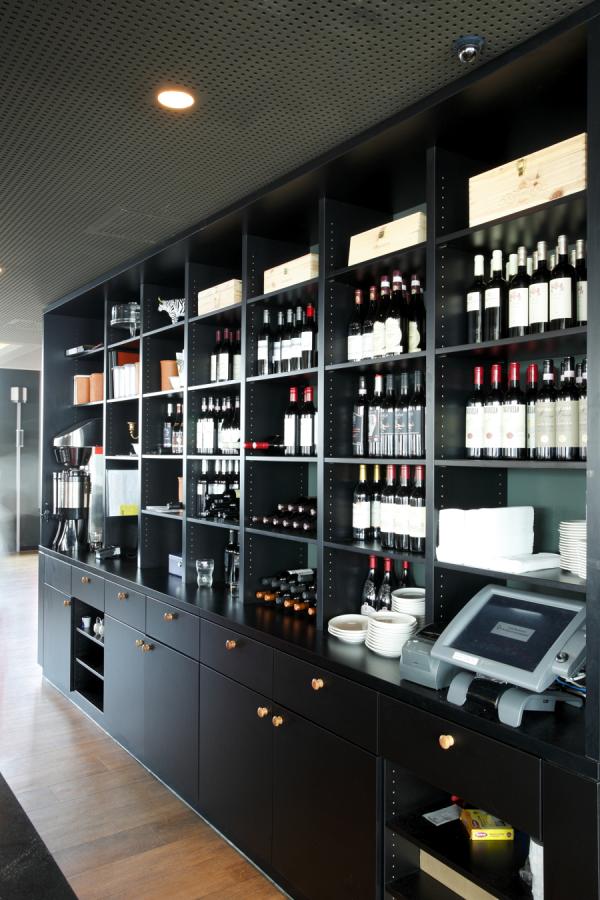 black backbar cabinet with closed storage space and open shelf for bottles